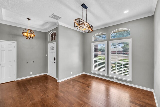 2201 Hereford Blvd, Midland, TX 79707 - unfurnished dining area with an inviting chandelier, a textured ceiling, baseboards, wood finished floors, and ornamental molding