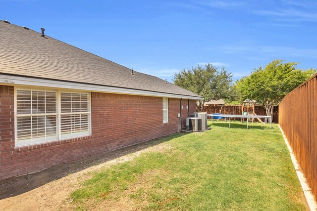 2201 Hereford Blvd, Midland, TX 79707 - view of yard featuring a fenced backyard, a trampoline, and cooling unit