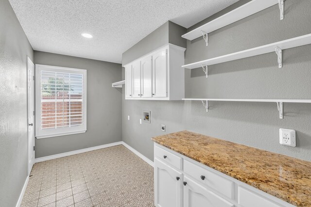 2201 Hereford Blvd, Midland, TX 79707 - laundry room featuring washer hookup, electric dryer hookup, a textured ceiling, baseboards, and light floors
