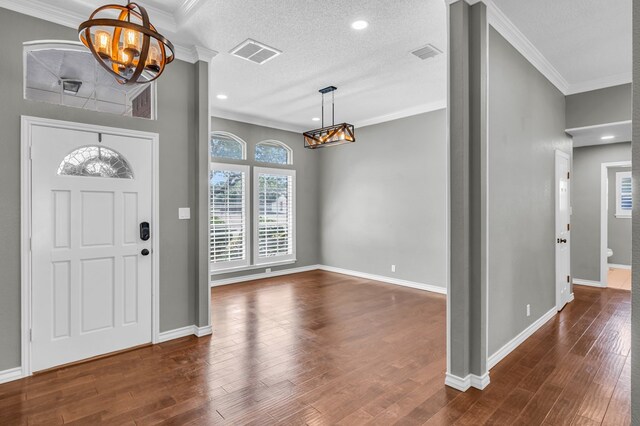 2201 Hereford Blvd, Midland, TX 79707 - entrance foyer featuring an inviting chandelier, baseboards, visible vents, and dark wood-style floors