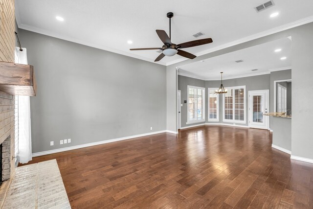 2201 Hereford Blvd, Midland, TX 79707 - unfurnished living room with visible vents, a fireplace, baseboards, ceiling fan with notable chandelier, and dark wood-style floors