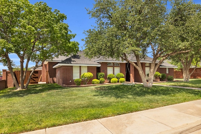 2201 Hereford Blvd, Midland, TX 79707 - mid-century inspired home with brick siding, fence, and a front yard