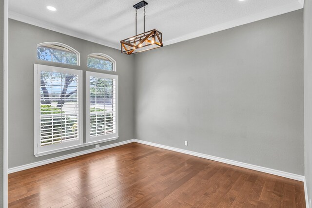 2201 Hereford Blvd, Midland, TX 79707 - unfurnished room featuring dark wood-style flooring, baseboards, a notable chandelier, ornamental molding, and recessed lighting