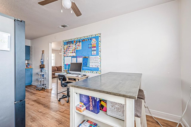 office with hardwood / wood-style flooring and ceiling fan