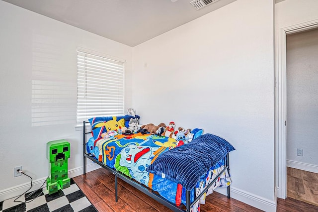 bedroom with hardwood / wood-style floors