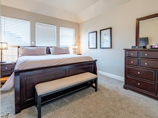 1906 Overshine Ln, Midland, TX 79705 - bedroom with light colored carpet, baseboards, and lofted ceiling