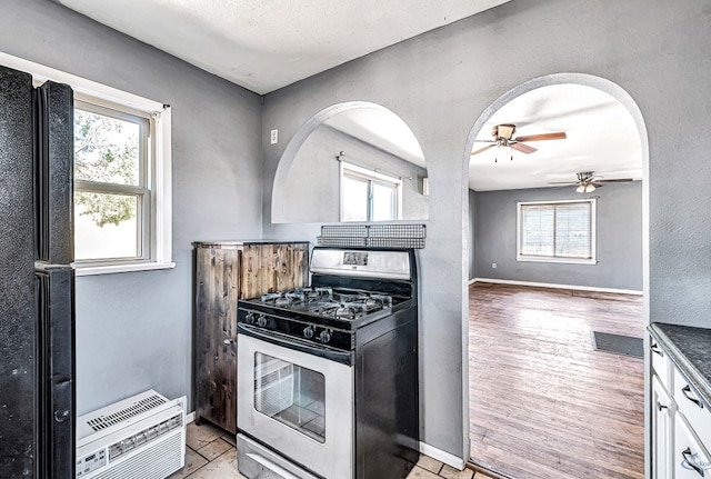 2109 Holloway Ave, Midland, TX 79705 - kitchen featuring stainless steel range with gas stovetop, ceiling fan, and healthy amount of natural light