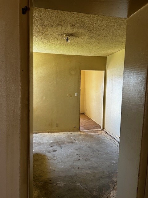 empty room with concrete flooring