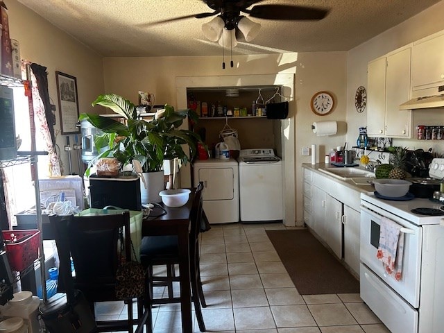 kitchen with washer and dryer, a textured ceiling, white cabinetry, and white range with electric cooktop