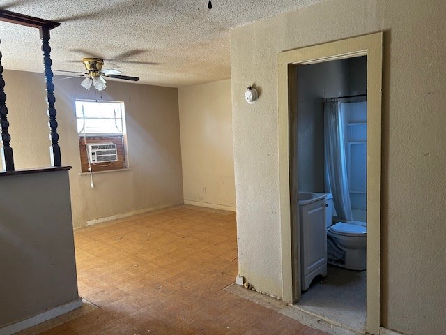 hall with a textured ceiling, light hardwood / wood-style flooring, and cooling unit