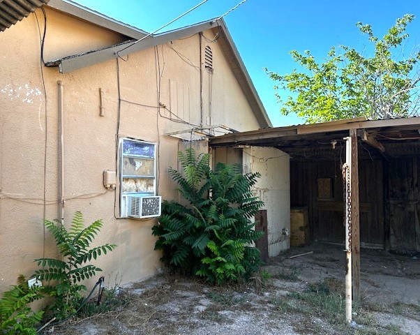 back of house featuring cooling unit