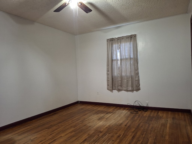 unfurnished room featuring ceiling fan, dark wood-type flooring, and a textured ceiling