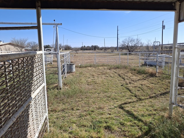 view of yard featuring fence and a rural view