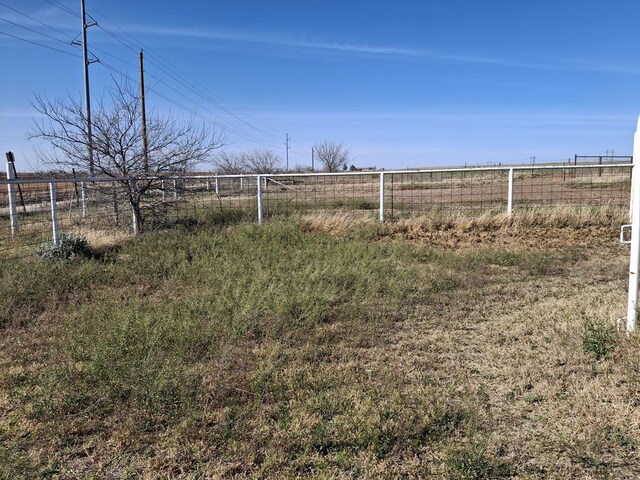 view of yard featuring fence and a rural view
