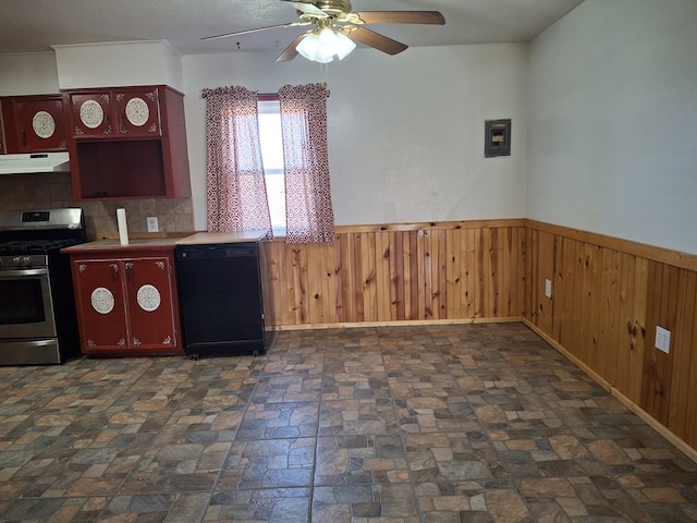 kitchen with a wainscoted wall, dishwasher, stainless steel range with gas stovetop, a ceiling fan, and under cabinet range hood