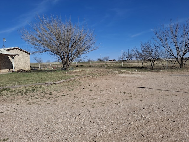 view of yard featuring fence and a rural view