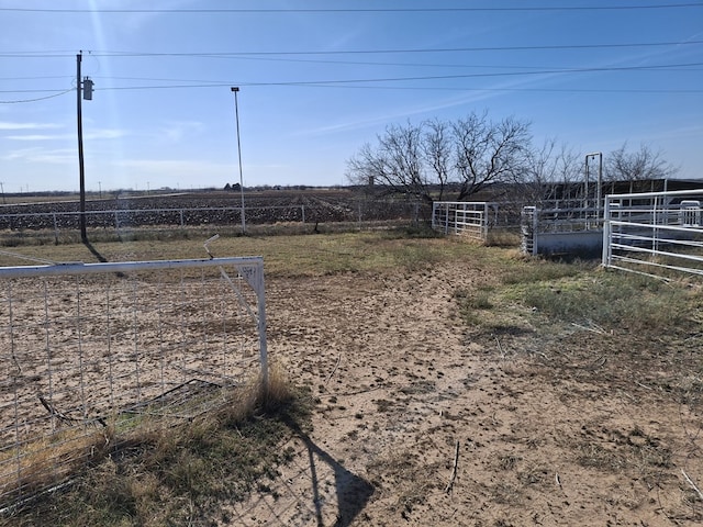 view of yard featuring fence and a rural view