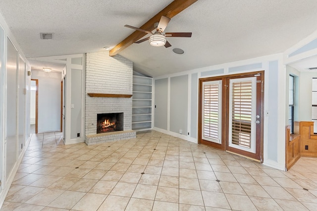 3400 Dentcrest Dr, Midland, TX 79707 - unfurnished living room with ceiling fan, built in shelves, a brick fireplace, a textured ceiling, and light tile patterned floors