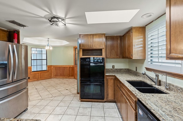 3400 Dentcrest Dr, Midland, TX 79707 - kitchen with stainless steel refrigerator with ice dispenser, wainscoting, brown cabinets, light stone countertops, and dishwasher