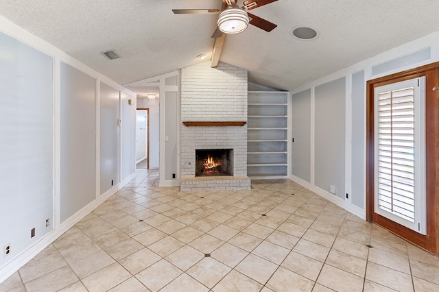 3400 Dentcrest Dr, Midland, TX 79707 - unfurnished living room with ceiling fan, built in shelves, a fireplace, a textured ceiling, and light tile patterned floors