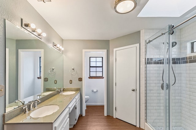 3400 Dentcrest Dr, Midland, TX 79707 - full bath with double vanity, a stall shower, wood finished floors, and healthy amount of natural light