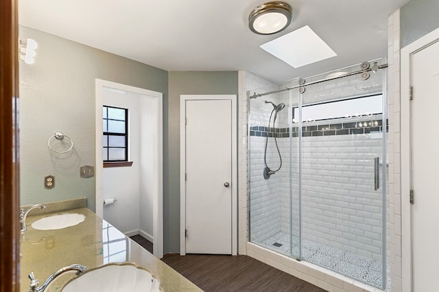 3400 Dentcrest Dr, Midland, TX 79707 - full bath with a skylight, a stall shower, wood finished floors, and double vanity