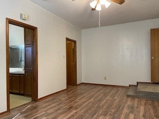 unfurnished room with ceiling fan, hardwood / wood-style floors, and a textured ceiling