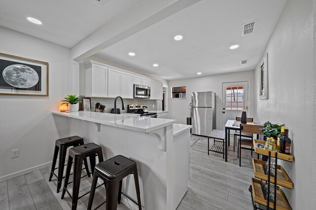 spare room with ceiling fan and light hardwood / wood-style floors