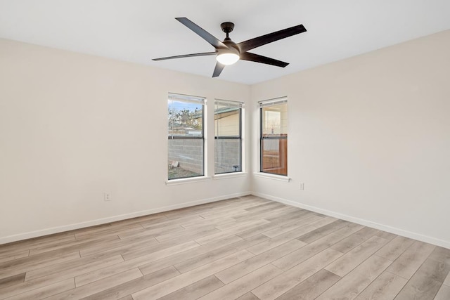 spare room featuring ceiling fan and light hardwood / wood-style floors