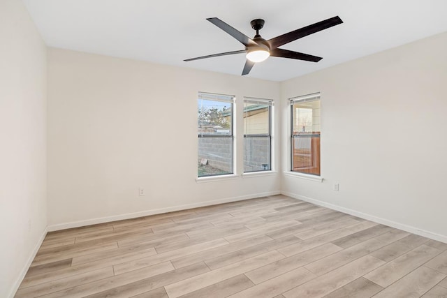 spare room with light wood-type flooring and ceiling fan