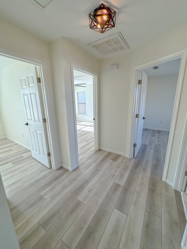 unfurnished bedroom featuring a closet, ceiling fan, and light hardwood / wood-style flooring