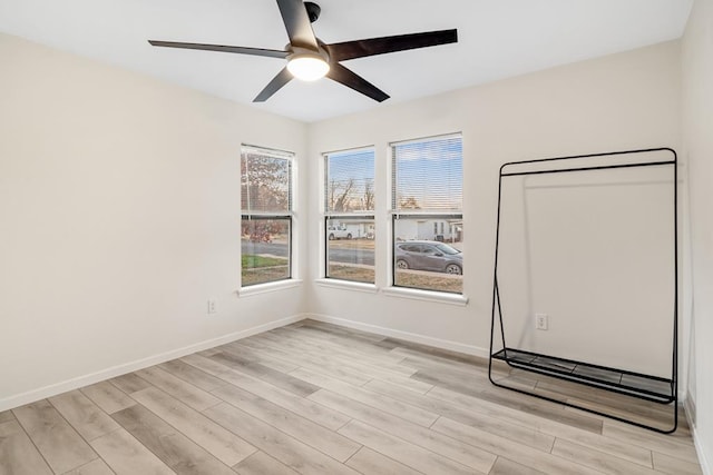 spare room featuring light wood-type flooring and ceiling fan