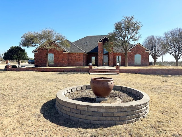 view of front of home featuring a front yard and brick siding