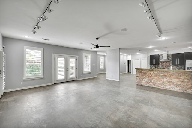 1 Lafayette Pl, Midland, TX 79705 - unfurnished living room featuring track lighting, concrete floors, a ceiling fan, and french doors