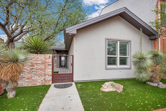 1 Lafayette Pl, Midland, TX 79705 - view of exterior entry featuring stucco siding and a yard