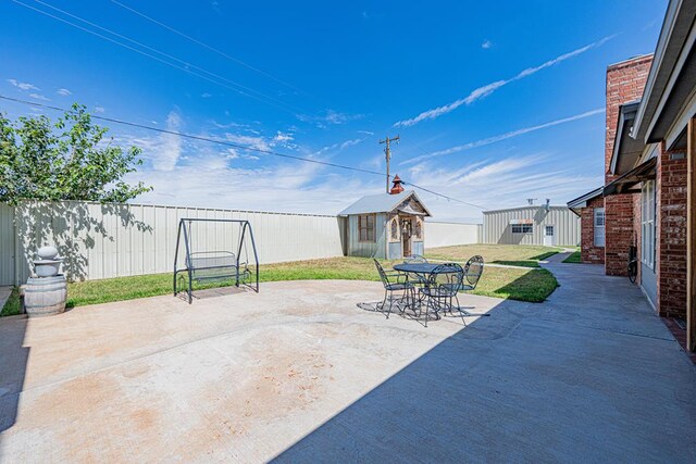 2108 S County Rd 1086, Midland, TX 79706 - view of patio / terrace with an outbuilding and outdoor dining area