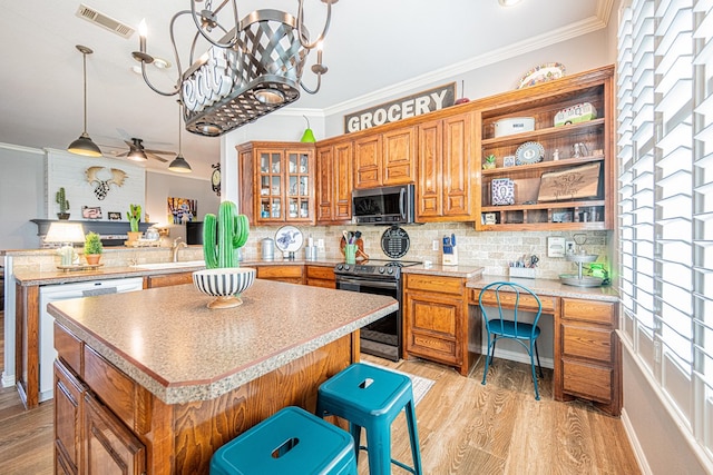 2108 S County Rd 1086, Midland, TX 79706 - kitchen featuring stainless steel microwave, range with electric stovetop, brown cabinets, a peninsula, and crown molding