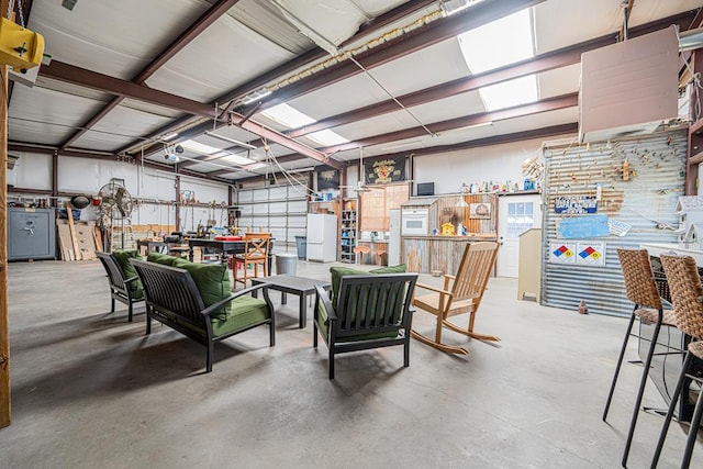 2108 S County Rd 1086, Midland, TX 79706 - garage featuring a workshop area and freestanding refrigerator