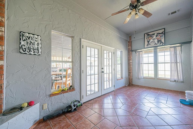 2108 S County Rd 1086, Midland, TX 79706 - doorway to outside featuring french doors, ceiling fan, tile patterned floors, and a textured wall