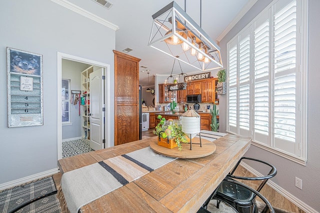 2108 S County Rd 1086, Midland, TX 79706 - dining space with ornamental molding and a chandelier