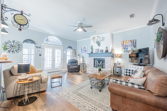 2108 S County Rd 1086, Midland, TX 79706 - living room featuring wood finished floors, crown molding, ceiling fan, a fireplace, and french doors