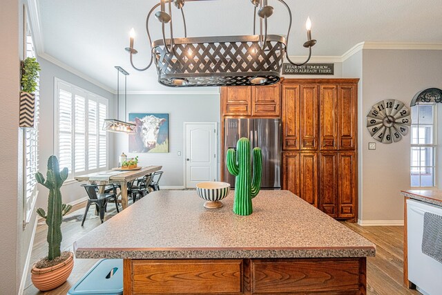 2108 S County Rd 1086, Midland, TX 79706 - kitchen with freestanding refrigerator, brown cabinets, crown molding, light wood finished floors, and a kitchen island
