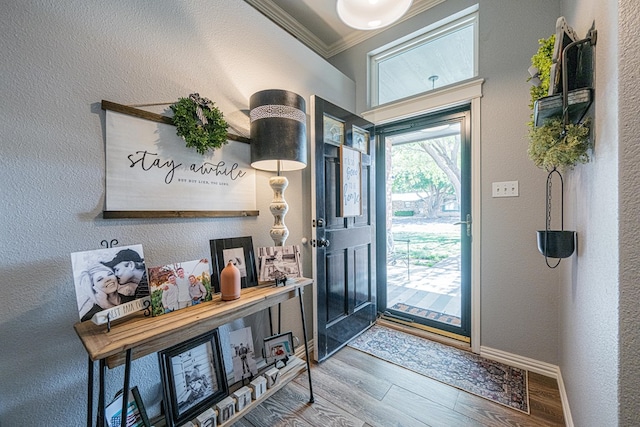 2108 S County Rd 1086, Midland, TX 79706 - entrance foyer with wood finished floors, ornamental molding, and a textured wall