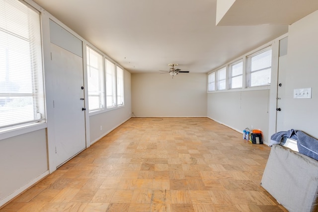 foyer featuring a ceiling fan and baseboards