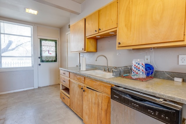 kitchen featuring dishwasher, light countertops, and a sink