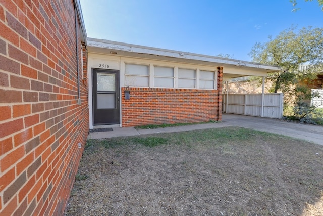doorway to property with brick siding