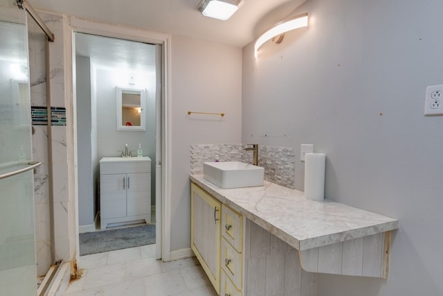 bathroom featuring a stall shower, vanity, and decorative backsplash