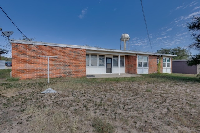 rear view of property with brick siding