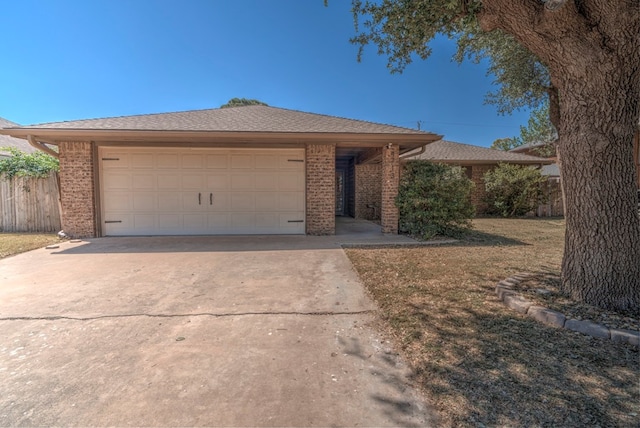 ranch-style house featuring brick siding, concrete driveway, and fence