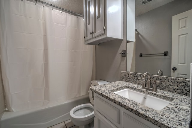 bathroom with a textured ceiling, toilet, vanity, and shower / tub combo with curtain